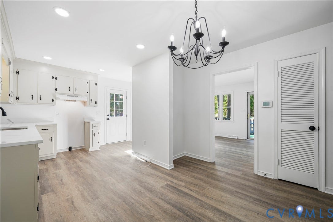 3622 New Bethel Road, Meherrin, VA 23954 Kitchen featuring white cabinetry, wood-finish flooring, recessed lighting, iron-finish chandelier, and louvered-panel closet doors
