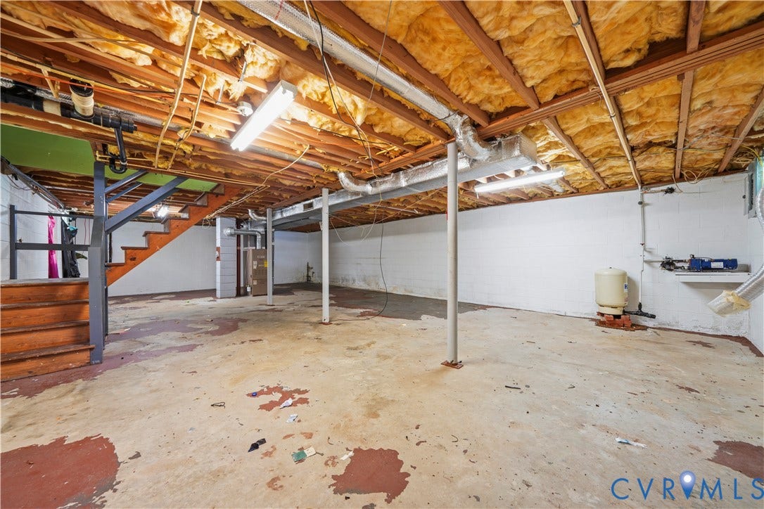 3622 New Bethel Road, Meherrin, VA 23954 Unfinished basement area featuring painted masonry walls, exposed ceiling joists with insulation, concrete flooring, metal support columns, and overhead strip lighting