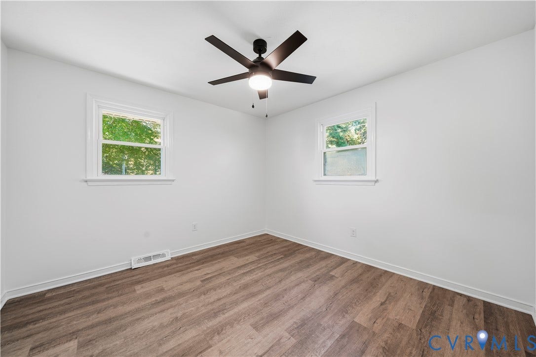 3622 New Bethel Road, Meherrin, VA 23954 Room featuring wood-finish flooring, dual windows, and a central ceiling fan with an integrated light fixture