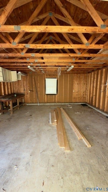 510 Old Town Drive, Ellerslie, Colonial Heights, VA 23834 Outbuilding interior featuring exposed wood truss ceiling, concrete flooring, built-in wooden workbench, and fluorescent lighting
