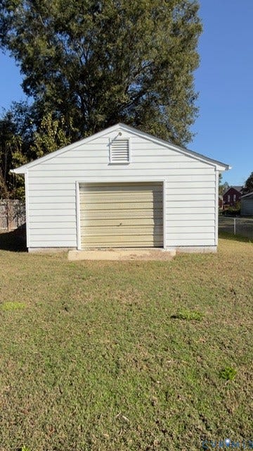 510 Old Town Drive, Ellerslie, Colonial Heights, VA 23834 Detached garage featuring white horizontal siding, a roll-up door, gable roof, and concrete foundation