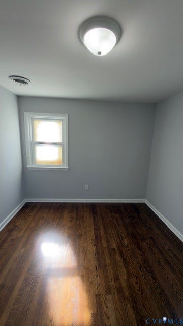 510 Old Town Drive, Ellerslie, Colonial Heights, VA 23834 Room featuring dark wood-finish flooring, light gray walls, a single window with white trim, and a ceiling-mounted flush light fixture