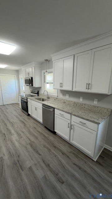 510 Old Town Drive, Ellerslie, Colonial Heights, VA 23834 Kitchen featuring white shaker-style cabinetry, neutral stone-finish countertops, stainless steel appliances, and wood-finish flooring