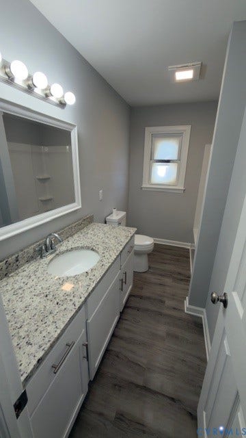 510 Old Town Drive, Ellerslie, Colonial Heights, VA 23834 Bathroom featuring white cabinetry, a stone-finish countertop with an integrated oval sink, wood-finish flooring, and a multi-bulb vanity light fixture