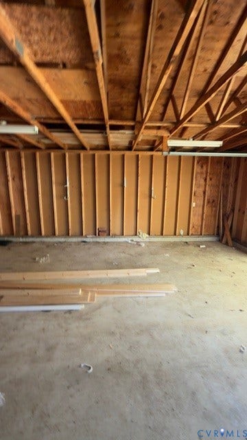 510 Old Town Drive, Ellerslie, Colonial Heights, VA 23834 Garage space featuring exposed wood-stud walls, concrete flooring, and an open-rafter ceiling with surface-mounted lighting