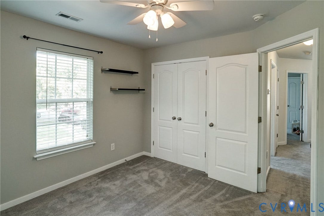 8909 Hollycroft Court, Mechanicsville, VA 23116 Interior space featuring neutral wall tones, wall-to-wall carpeting, a double-door closet, multi-tier wall shelving, and a ceiling-mounted light fixture