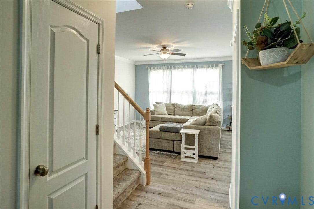 8909 Hollycroft Court, Mechanicsville, VA 23116 Interior space featuring wood-finish flooring, a ceiling fan with integrated lighting, a staircase with a wooden handrail, and white interior doors