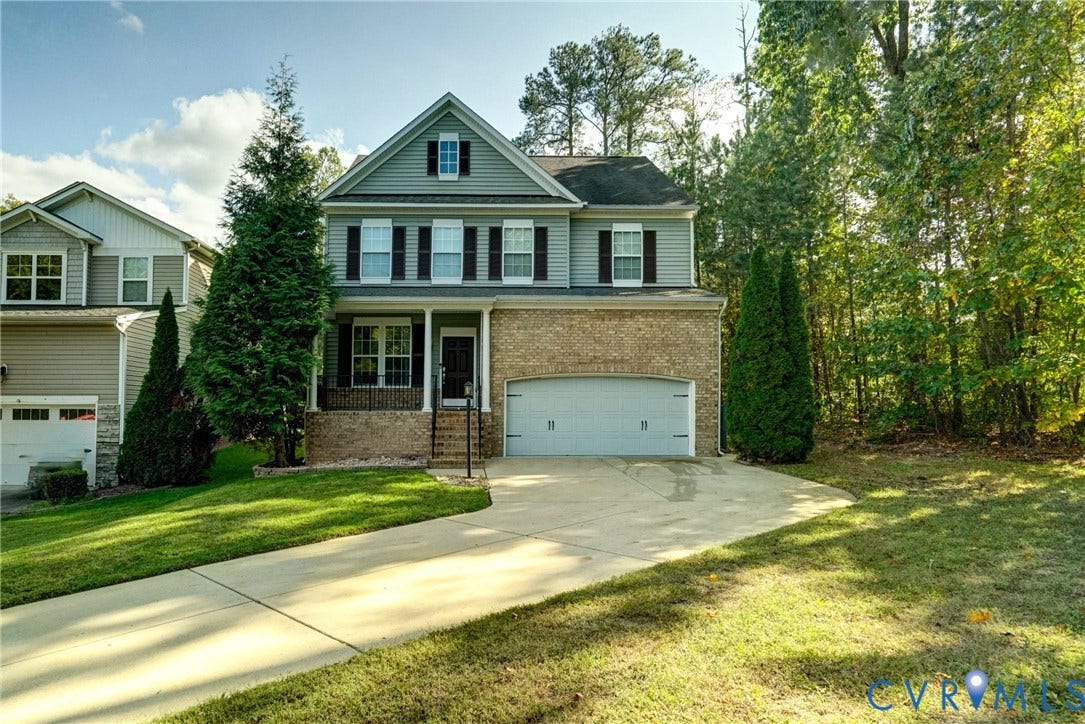 8909 Hollycroft Court, Mechanicsville, VA 23116 Two-story residence featuring a combination of brick and lap siding, a front-facing attached two-car garage, shuttered windows, and a covered entryway
