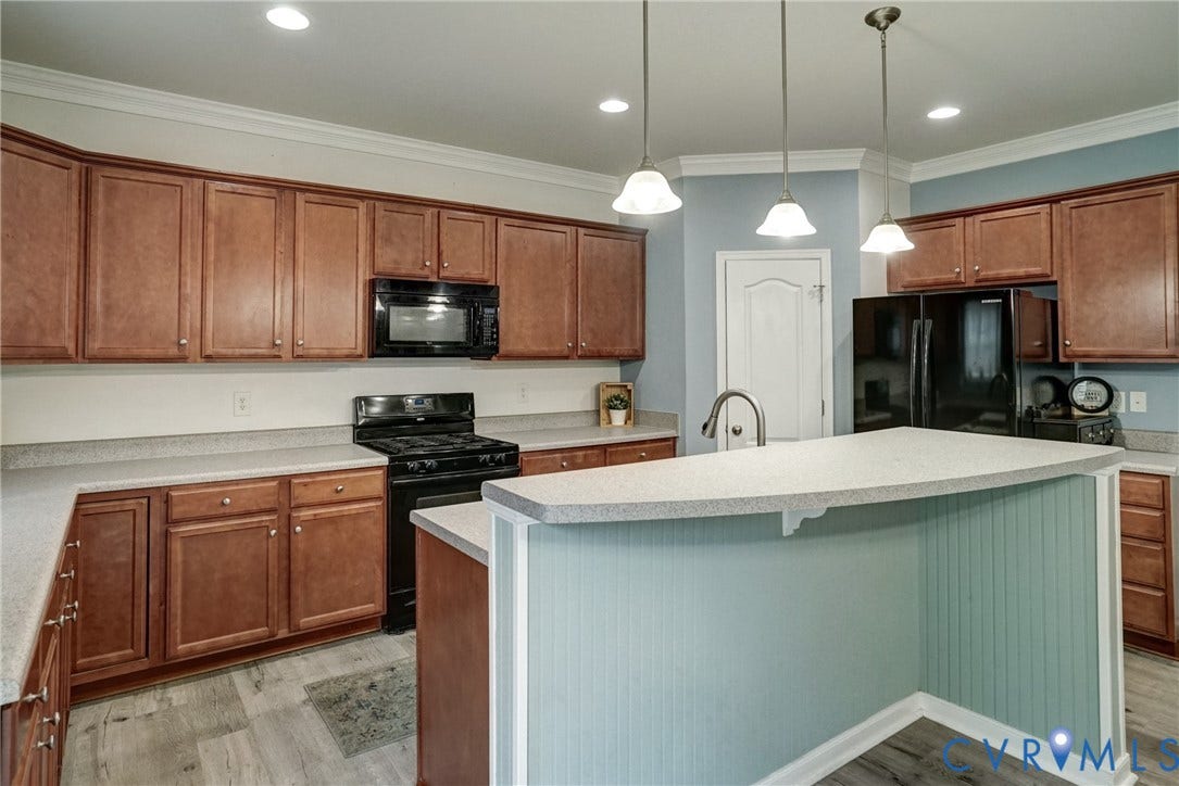 8909 Hollycroft Court, Mechanicsville, VA 23116 Kitchen featuring wood cabinetry, stone-finish countertops, an island with beadboard paneling, recessed lighting, and a trio of pendant lights