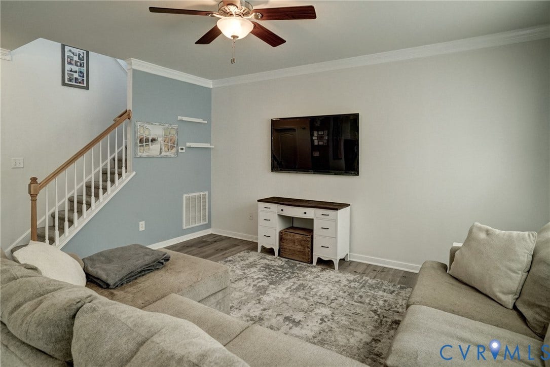8909 Hollycroft Court, Mechanicsville, VA 23116 Wood-finish flooring, staircase with a wood handrail and white balusters, ceiling fan with integrated lighting, and crown molding
