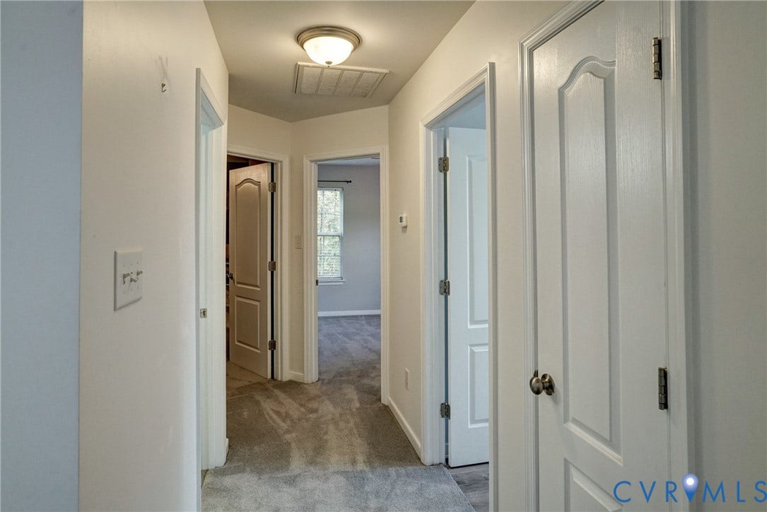 8909 Hollycroft Court, Mechanicsville, VA 23116 Interior hallway featuring wall-to-wall carpeting, flush-mount lighting, and four-panel interior doors with metallic hardware