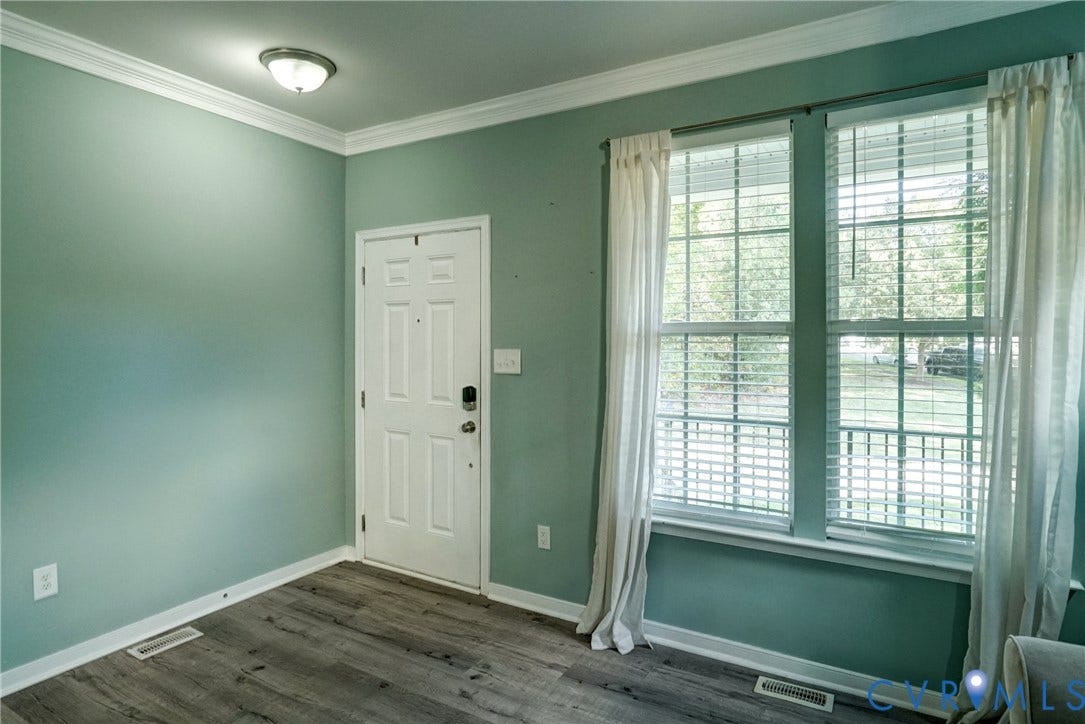 8909 Hollycroft Court, Mechanicsville, VA 23116 Room featuring wood-finish flooring, crown molding, double-pane windows with muntins, and a six-panel exterior door