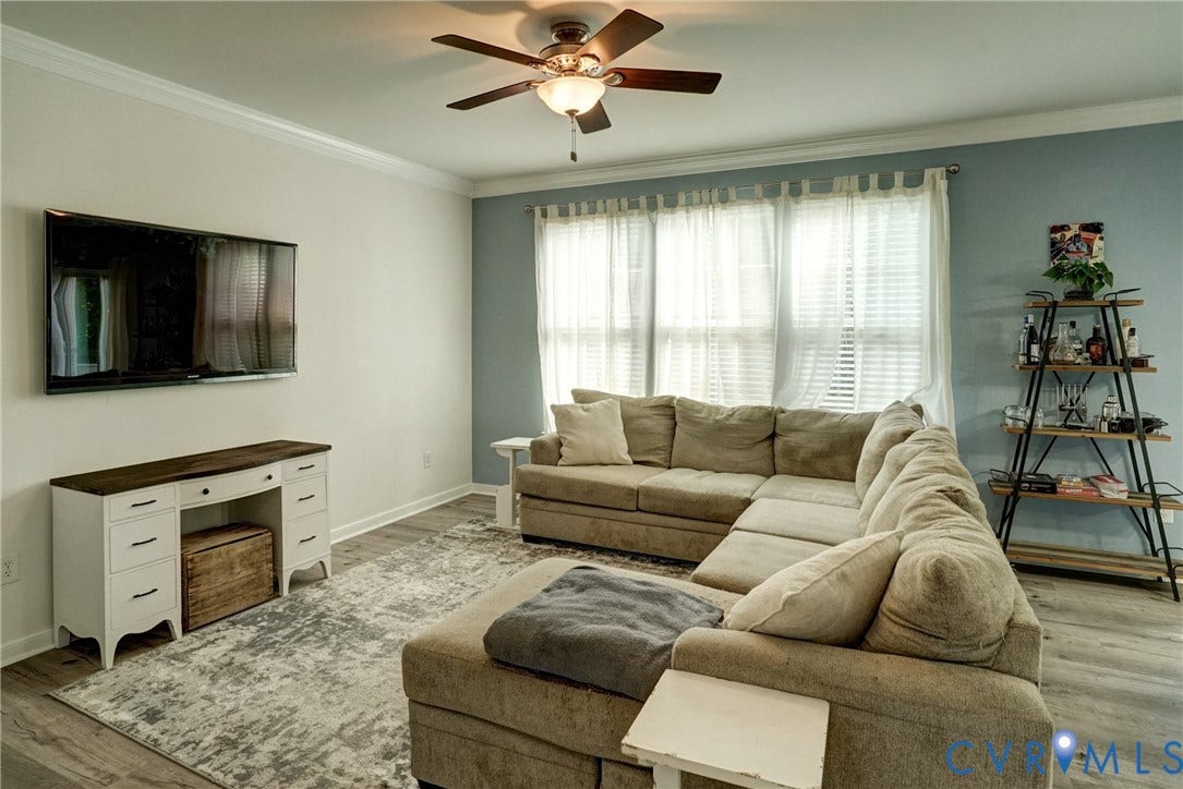 8909 Hollycroft Court, Mechanicsville, VA 23116 Room featuring wood-finish flooring, a multi-pane window configuration, and a central ceiling fan with an integrated light fixture