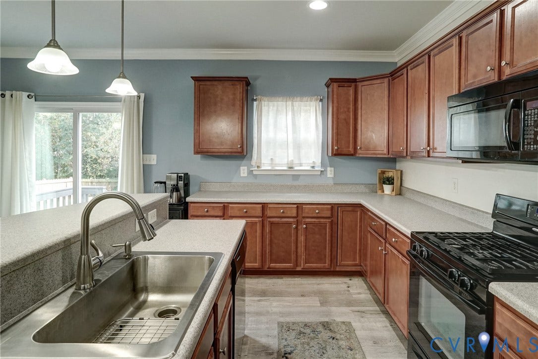 8909 Hollycroft Court, Mechanicsville, VA 23116 Kitchen featuring shaker-style wood cabinetry, stone-composite countertops, stainless steel undermount sink with arched pull-down faucet, black gas range with microwave, and wood-finish flooring