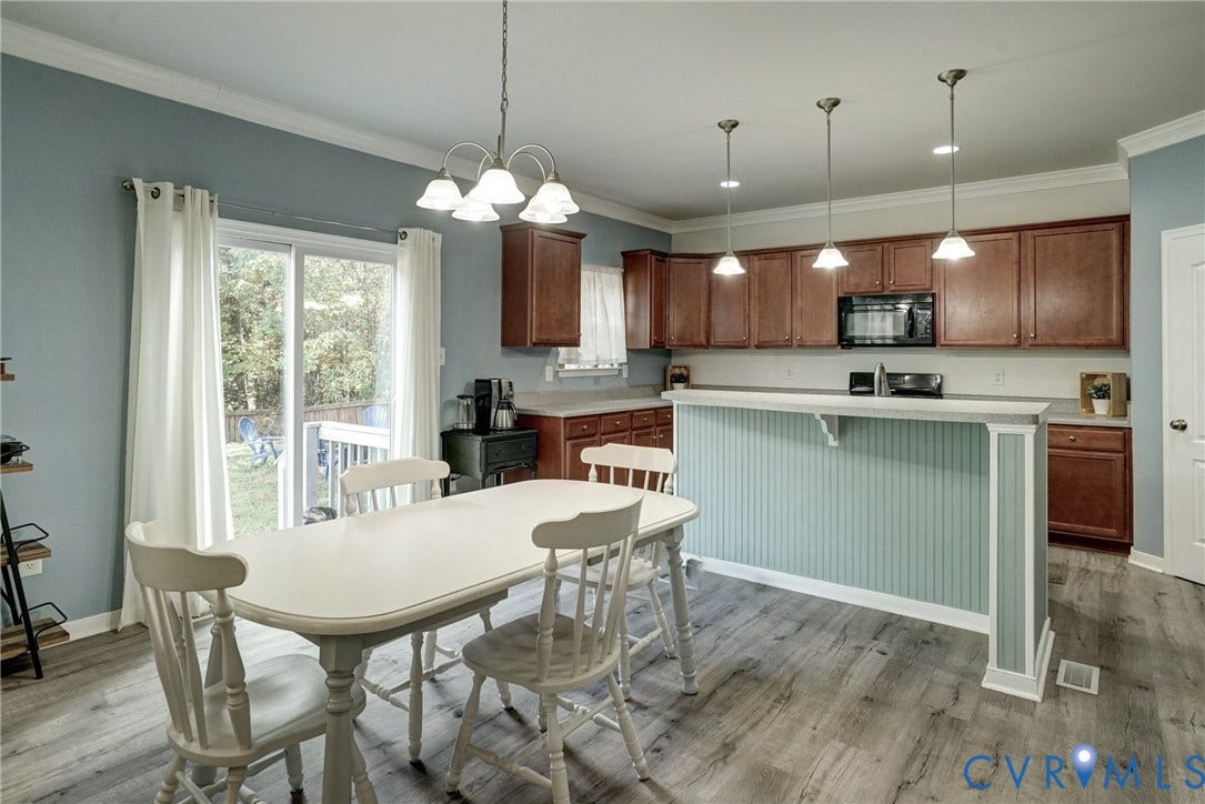 8909 Hollycroft Court, Mechanicsville, VA 23116 Kitchen featuring stained wood cabinetry, a peninsula with beadboard paneling, wood-finish flooring, recessed lighting, and a multi-light chandelier