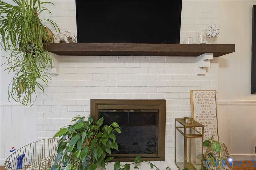 1101 Arch Hill Drive, Chesterfield, VA 23236 Fireplace featuring a painted white brick surround, dark-stained timber mantel, and metal glass-panel firebox enclosure