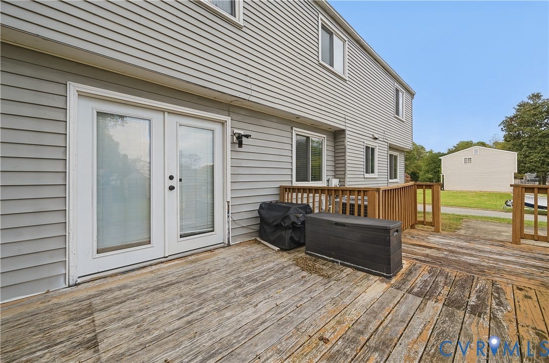 1101 Arch Hill Drive, Chesterfield, VA 23236 Exterior wood deck featuring a railing and double glass-paneled doors leading into the residence, complemented by horizontal vinyl siding