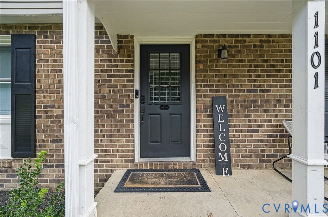 1101 Arch Hill Drive, Chesterfield, VA 23236 Covered front porch featuring a brick facade, decorative shutters, and a dark-toned door with window panes