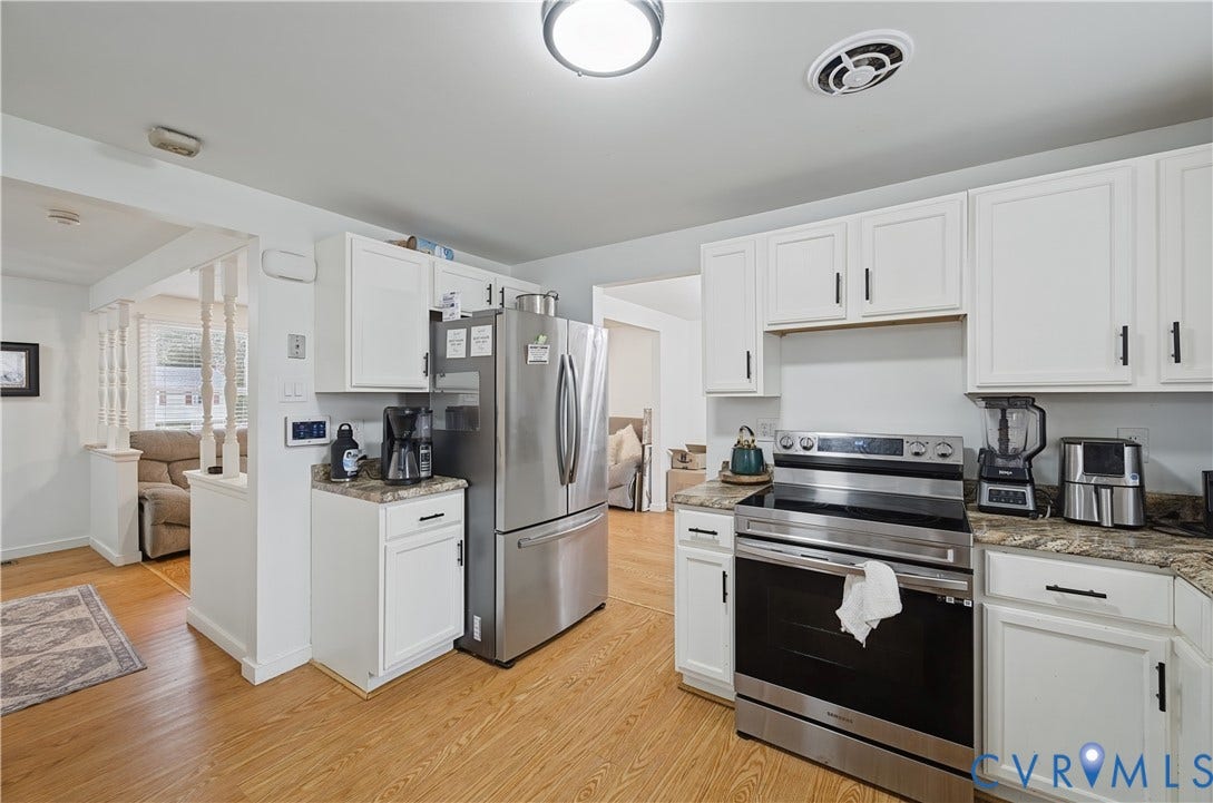 1101 Arch Hill Drive, Chesterfield, VA 23236 Kitchen featuring white cabinetry, stone-finish countertops, stainless steel appliances, and wood-finish flooring