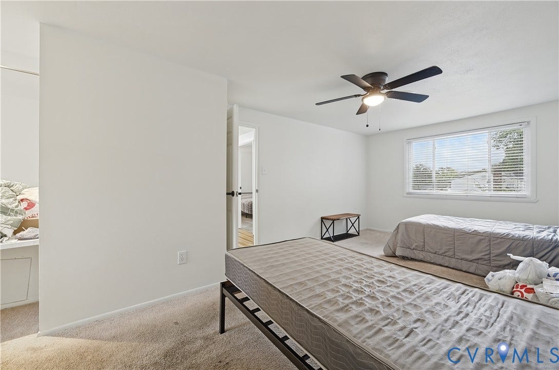 1101 Arch Hill Drive, Chesterfield, VA 23236 Neutral-toned interior featuring wall-to-wall carpeting, a multi-blade ceiling fan with integrated lighting, and a single-hung window with horizontal blinds