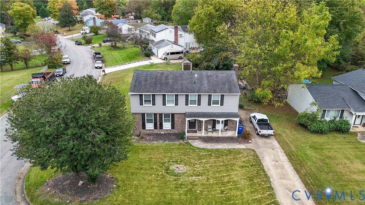 1101 Arch Hill Drive, Chesterfield, VA 23236 Two-story exterior featuring a brick facade, gray horizontal siding, an asphalt shingle roof, a covered front porch, and a concrete driveway