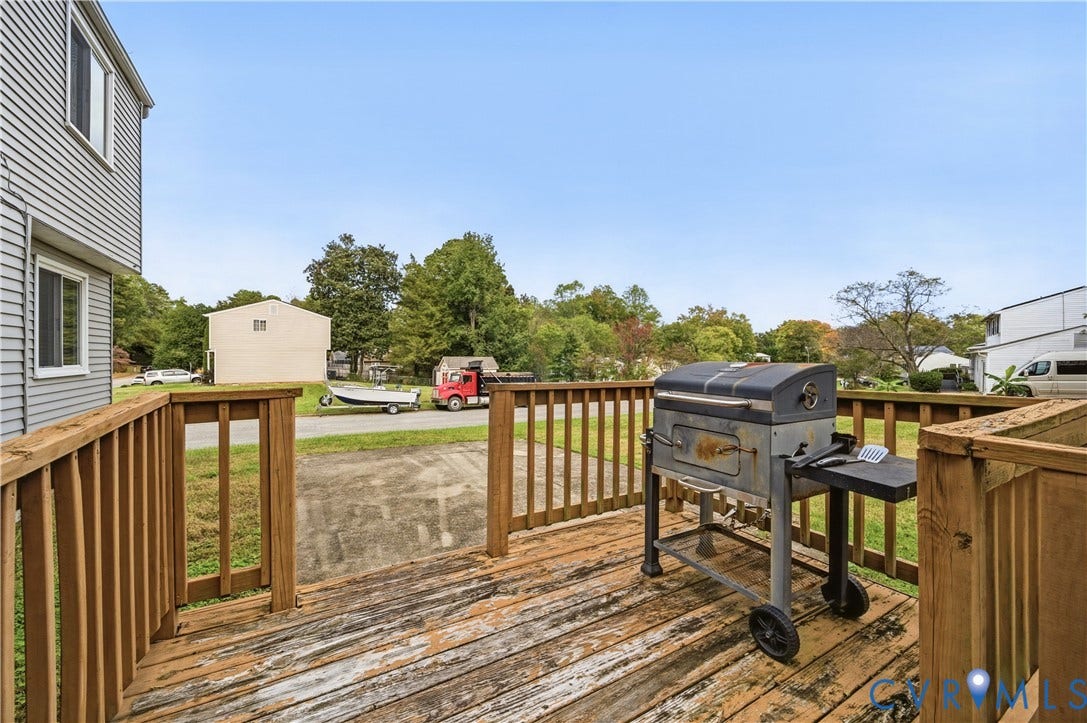 1101 Arch Hill Drive, Chesterfield, VA 23236 Elevated wood-plank deck featuring a perimeter railing and concrete ground-level surface