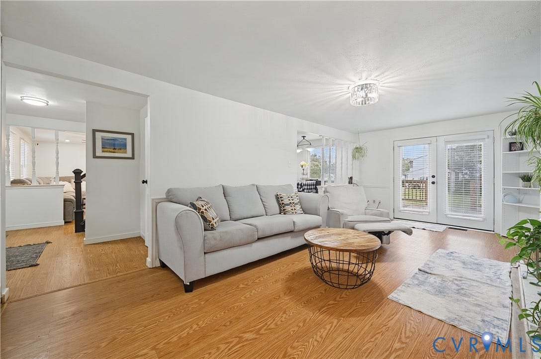 1101 Arch Hill Drive, Chesterfield, VA 23236 Living area featuring wood-finish flooring, white walls, built-in shelving, a glass-panel chandelier, and double doors providing exterior access