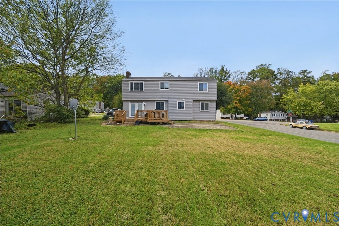 1101 Arch Hill Drive, Chesterfield, VA 23236 Two-story gray siding exterior featuring a wood deck and expansive lawn
