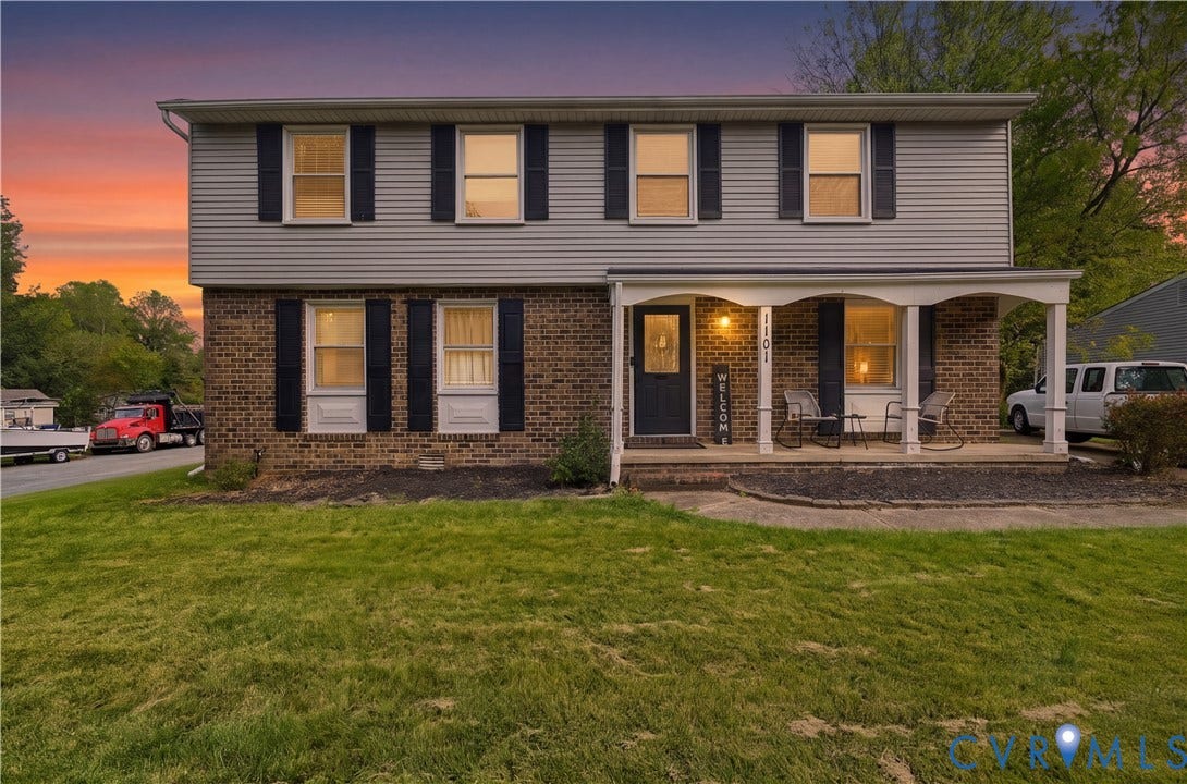 1101 Arch Hill Drive, Chesterfield, VA 23236 Two-story colonial exterior featuring a mixed brick and horizontal siding facade, covered front porch with arched supports, and decorative window shutters