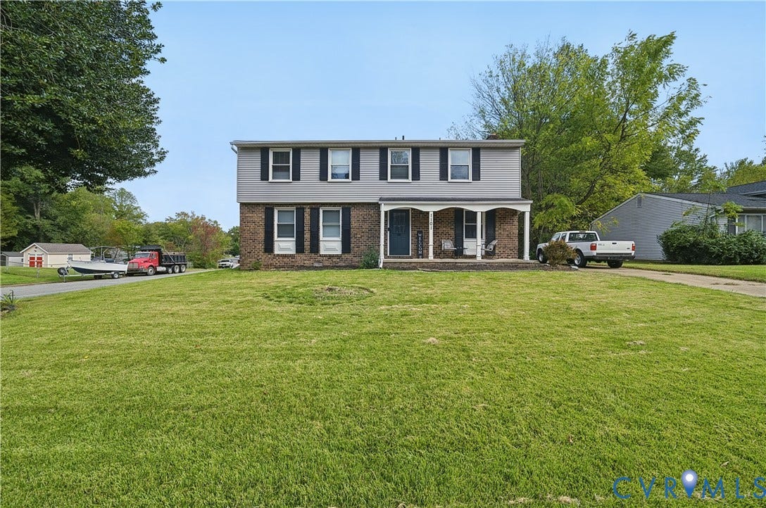 1101 Arch Hill Drive, Chesterfield, VA 23236 Two-story exterior featuring a brick and siding facade, covered front porch with arched supports, and black window shutters