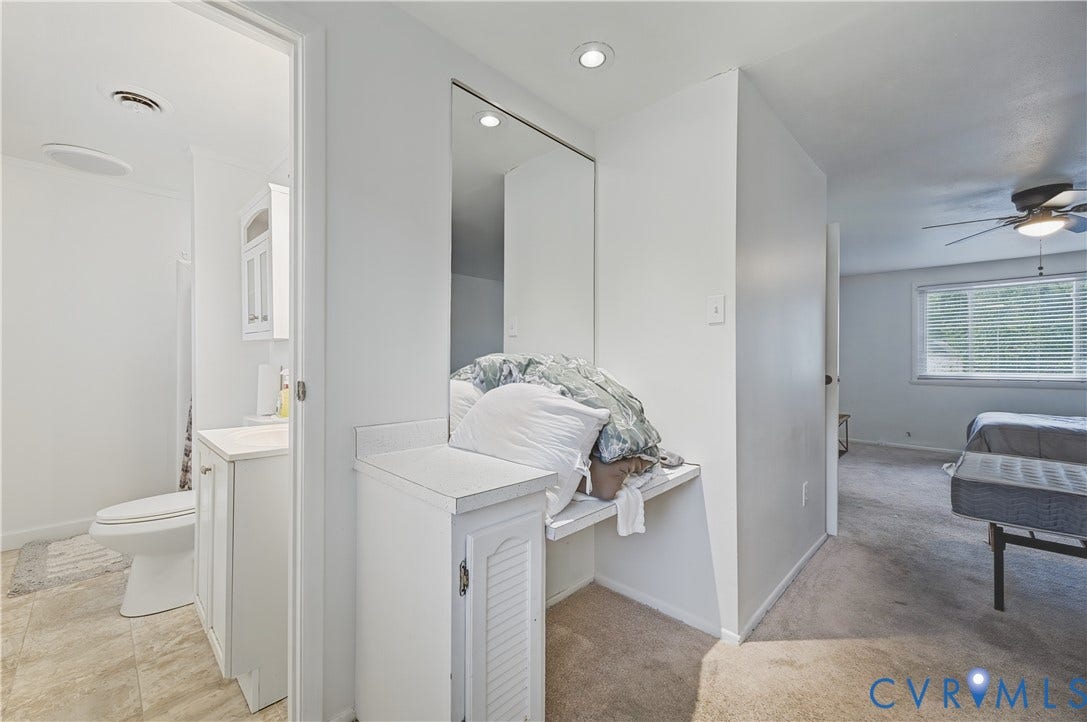 1101 Arch Hill Drive, Chesterfield, VA 23236 Built-in vanity with a countertop, full-height wall mirror, recessed ceiling lighting, and neutral-tone carpeting