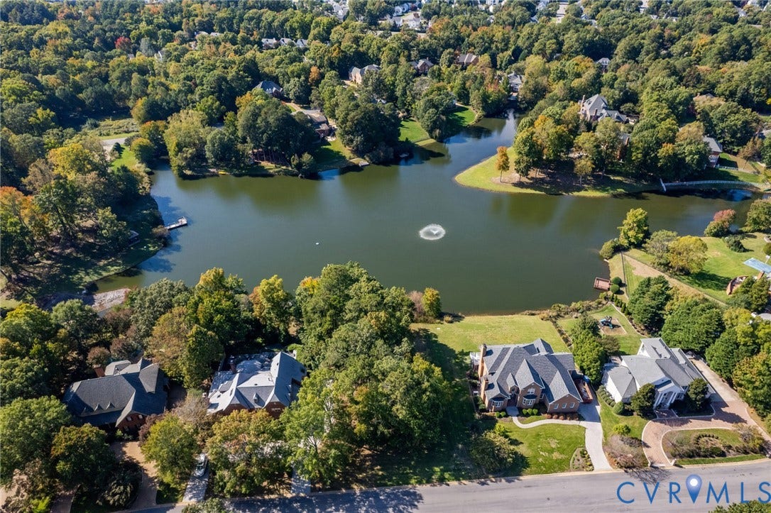 11433 Barrington Bridge Court, Henrico, VA 23233 Aerial perspective of waterfront properties featuring expansive pond frontage, mature wooded landscape, and paved driveways