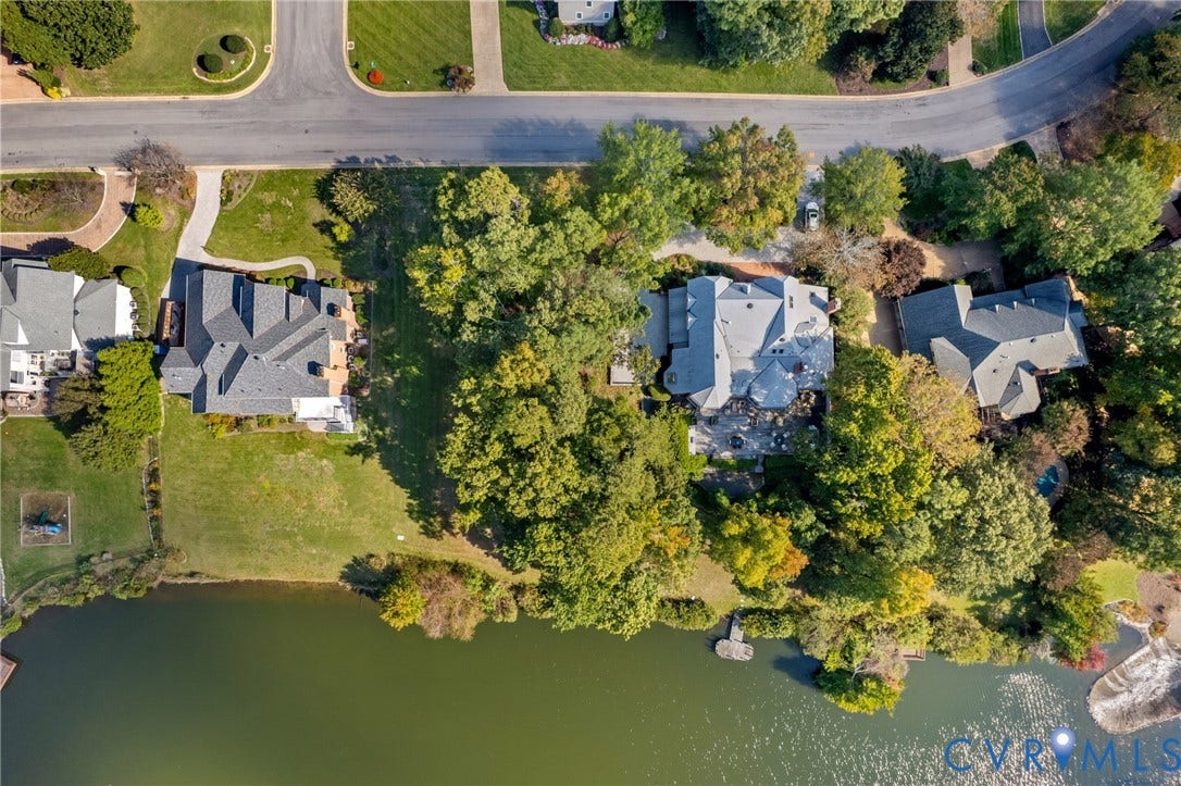 11433 Barrington Bridge Court, Henrico, VA 23233 Aerial perspective featuring a waterfront property with extensive tree canopy, a paved driveway, and established landscaping