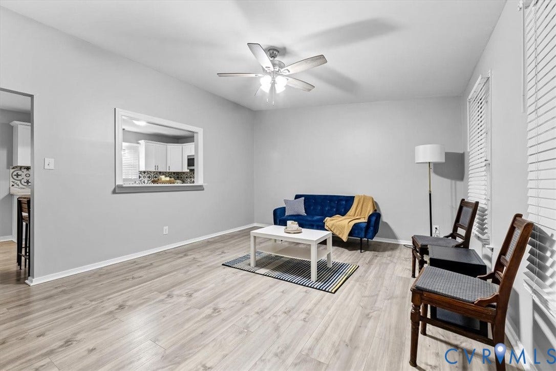 11518 Frederick Farms Circle, Midlothian, VA 23112 Neutral walls, wood-finish flooring, ceiling fan with integrated lighting, and a passthrough opening