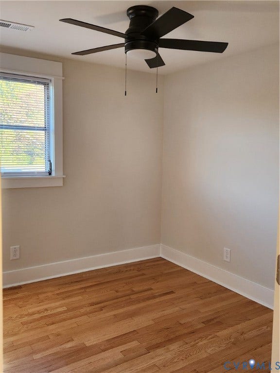 1209 Newtown Road, King & Queen, VA 23148 Room featuring wood-finish flooring, a multi-blade ceiling fan with integrated lighting, and a window with white trim