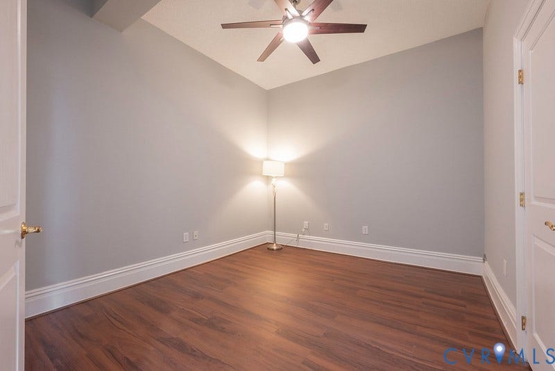 6 N 6th Street, #U3C, Downtown, Richmond, VA 23219 Room featuring wood-finish flooring, vaulted ceilings, and a ceiling fan with integrated light fixture