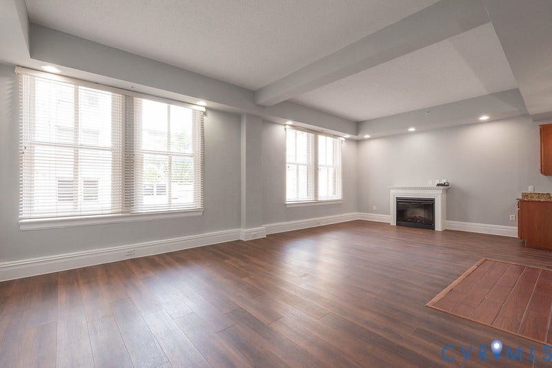 6 N 6th Street, #U3C, Downtown, Richmond, VA 23219 Living area featuring wood-finish flooring, recessed lighting, multi-pane windows, and a fireplace with a mantel