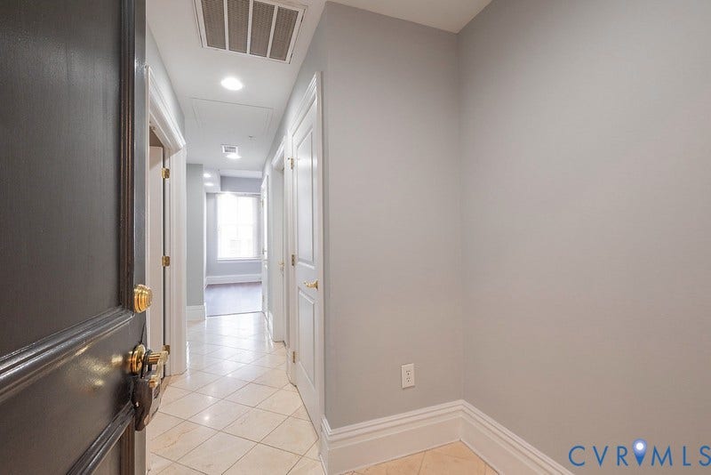 6 N 6th Street, #U3C, Downtown, Richmond, VA 23219 Interior entry featuring light-toned tile flooring, neutral wall paint, recessed lighting, and multi-panel doors with metallic hardware