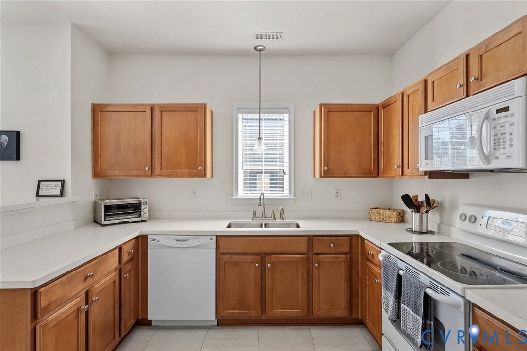 4914 Terrace Arbor Circle, Midlothian, VA 23112 Kitchen featuring natural wood cabinetry, solid-surface countertops, dual-basin stainless steel sink, LVT flooring, and integrated white appliances