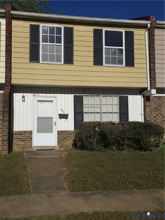 413 Adamson Street, Henrico, VA 23075 Exterior facade featuring horizontal siding, brick masonry detailing, decorative window shutters, and a multi-pane front entry door