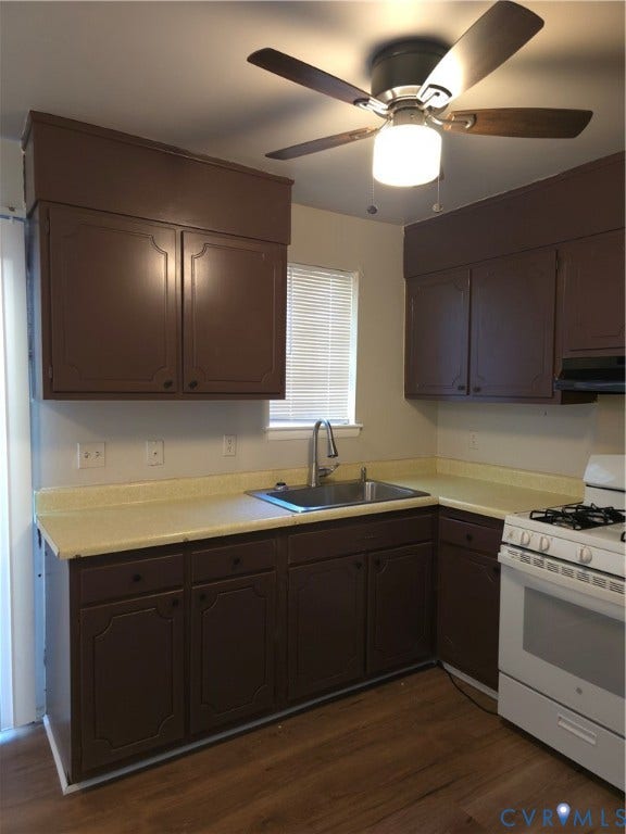 413 Adamson Street, Henrico, VA 23075 Kitchen featuring dark cabinetry, solid-surface countertops, stainless steel sink with high-arc faucet, wood-finish flooring, and ceiling-mounted light fixture