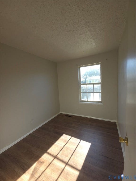 413 Adamson Street, Henrico, VA 23075 Room featuring neutral-toned walls, wood-finish flooring, and a single-hung window with a multi-pane grid