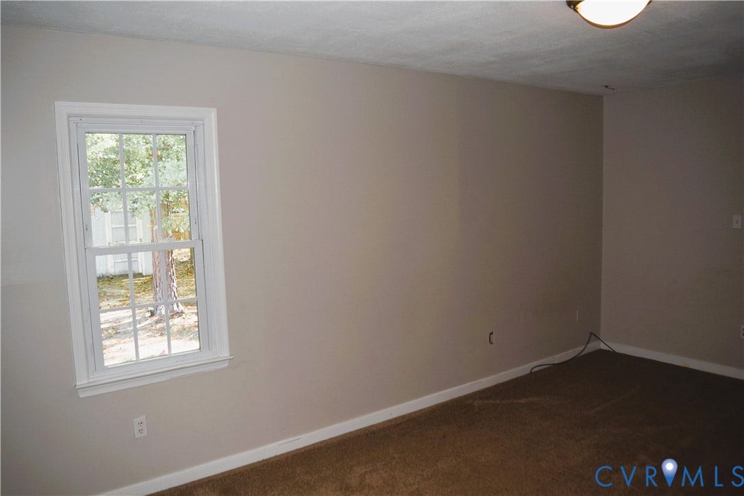 8905 Hawkbill Road, Chesterfield, VA 23237 Neutral-toned walls, double-hung window with colonial grille pattern, carpeting, and flush-mount ceiling lighting