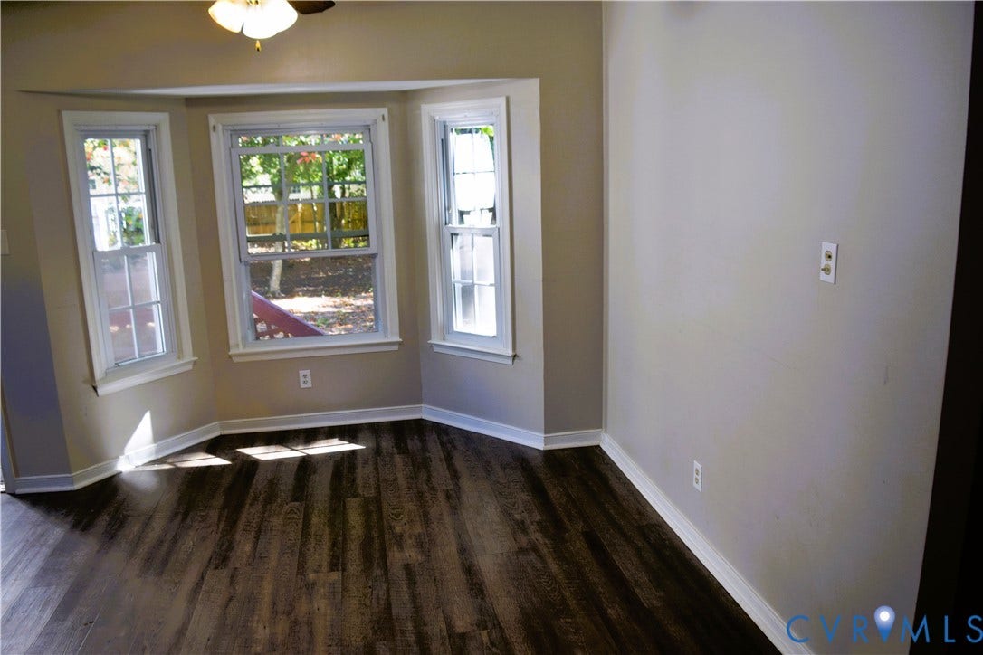 8905 Hawkbill Road, Chesterfield, VA 23237 Bay window with multi-pane windows, wood-finish flooring, and a ceiling-mounted light fixture