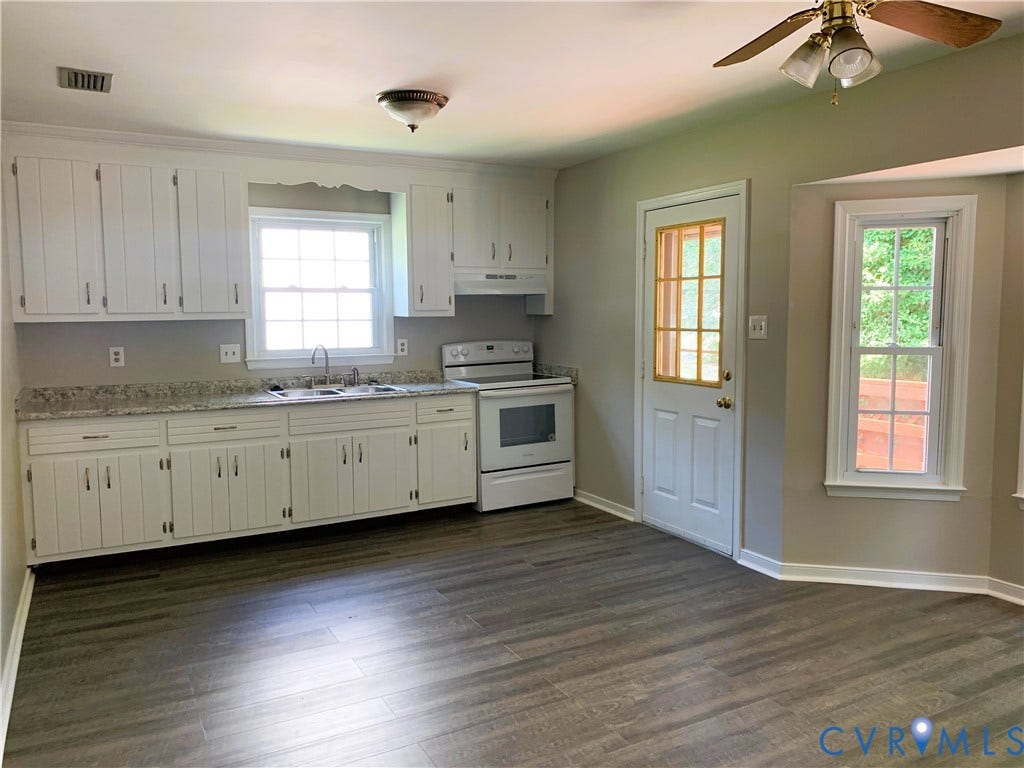 8905 Hawkbill Road, Chesterfield, VA 23237 Kitchen featuring white cabinetry, stone-finish countertops, wood-finish flooring, a multi-pane exterior door, and a bay window