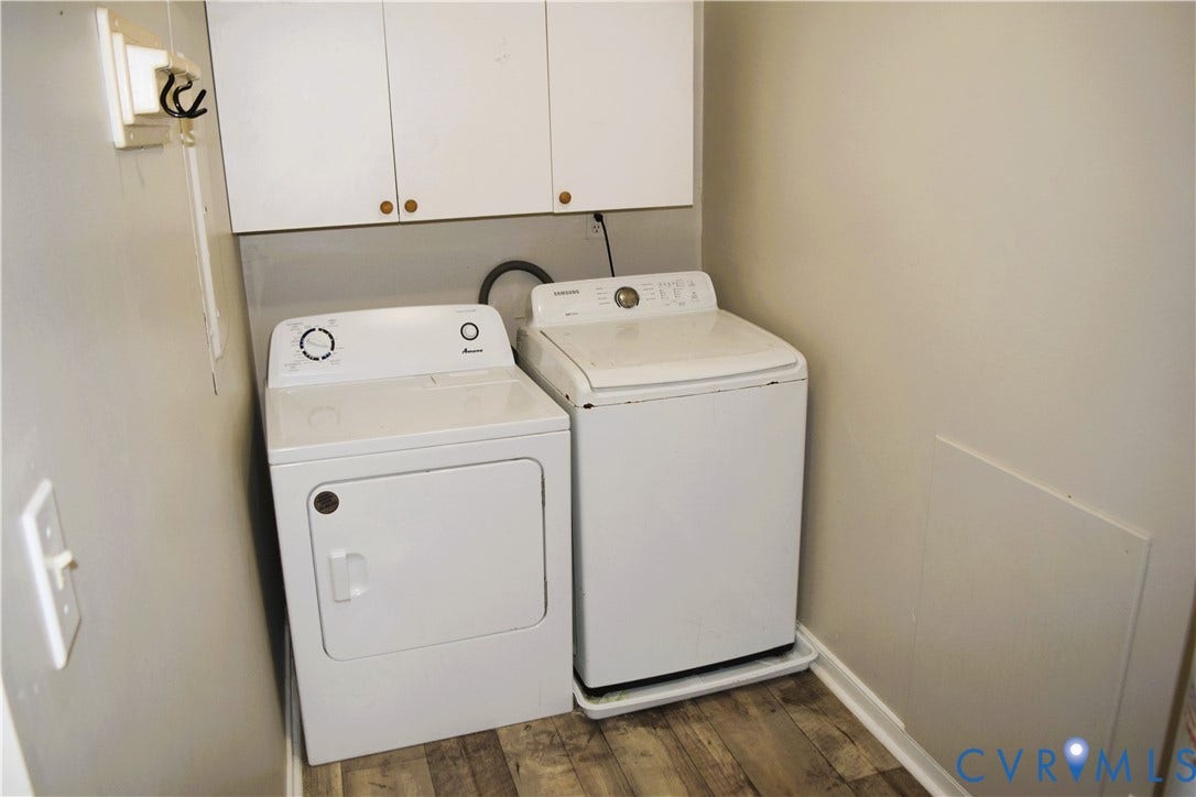 8905 Hawkbill Road, Chesterfield, VA 23237 Laundry area featuring wood-finish flooring and white upper cabinetry