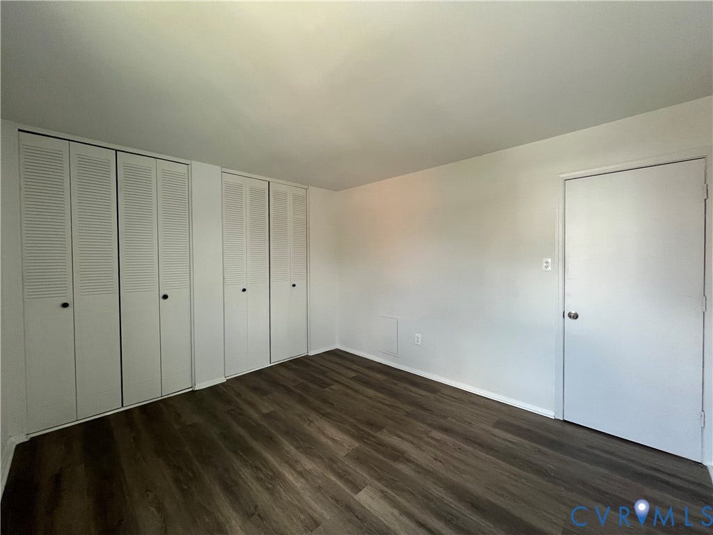 39 Rock Garden Lane, Henrico, VA 23228 Neutral-toned interior space featuring wood-finish flooring and two sets of built-in louvered-door closets