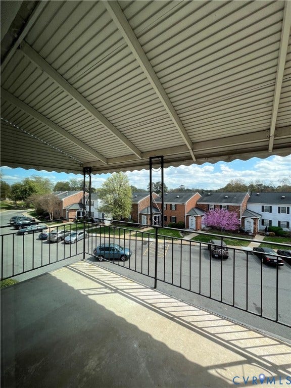 39 Rock Garden Lane, Henrico, VA 23228 Covered balcony featuring concrete flooring and black metal railing