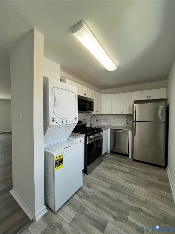39 Rock Garden Lane, Henrico, VA 23228 Kitchen featuring white cabinetry, stone-finish countertops, subway tile backsplash, wood-finish flooring, and stainless steel appliances