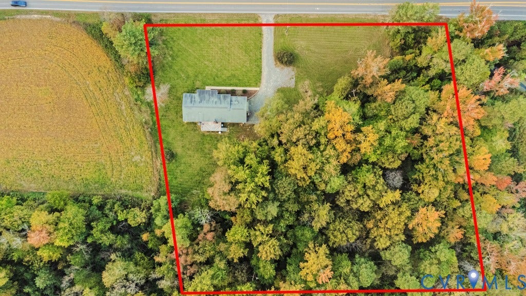 Expansive parcel featuring a mix of open cleared grounds and mature forest canopy